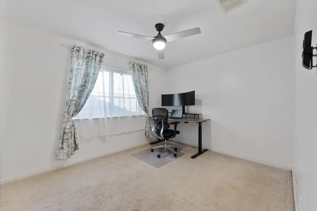 a bedroom with furniture and a flat screen tv