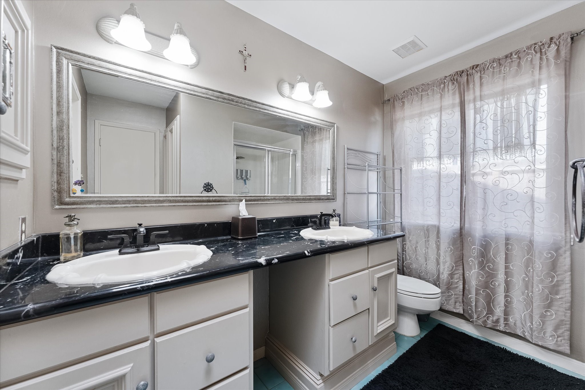 11854 Briar Forest Drive Houston, TX 77077 - Photo 18 of 21 a bathroom with a granite countertop sink a toilet and a mirror