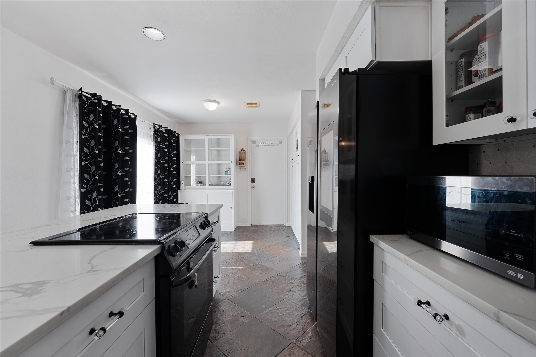 11854 Briar Forest Drive Houston, TX 77077 - Photo 4 of 21 a kitchen with granite countertop a refrigerator and a sink