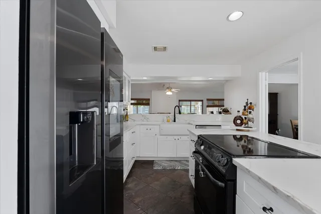 a kitchen with a sink stainless steel appliances and cabinets
