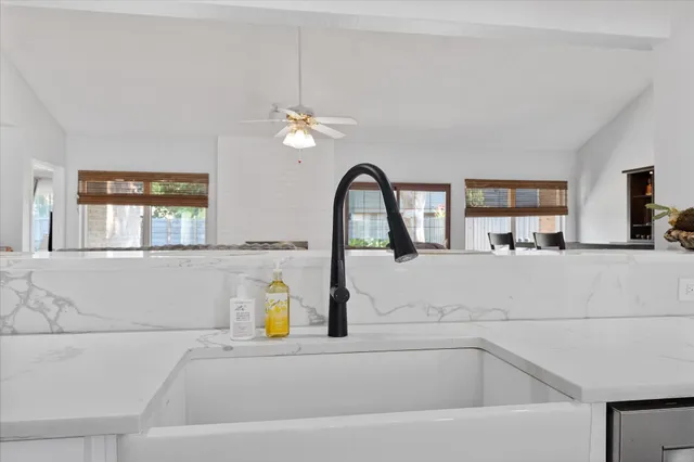 a kitchen with a sink appliances and cabinets