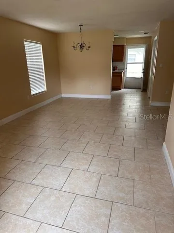 a view of a kitchen with furniture and an empty room
