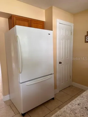 a white refrigerator freezer sitting in a kitchen