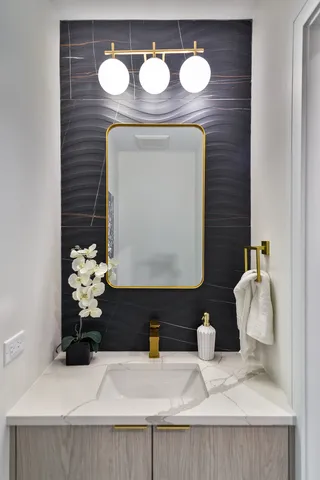a bathroom with a sink and a mirror