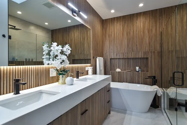 a bathroom with a bathtub sink and mirror