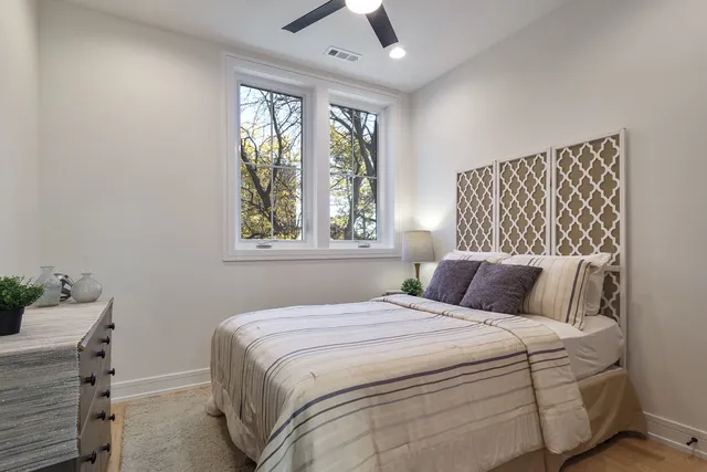 a bedroom with a large bed and a window
