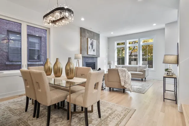 a view of a dining room with furniture wooden floor and chandelier