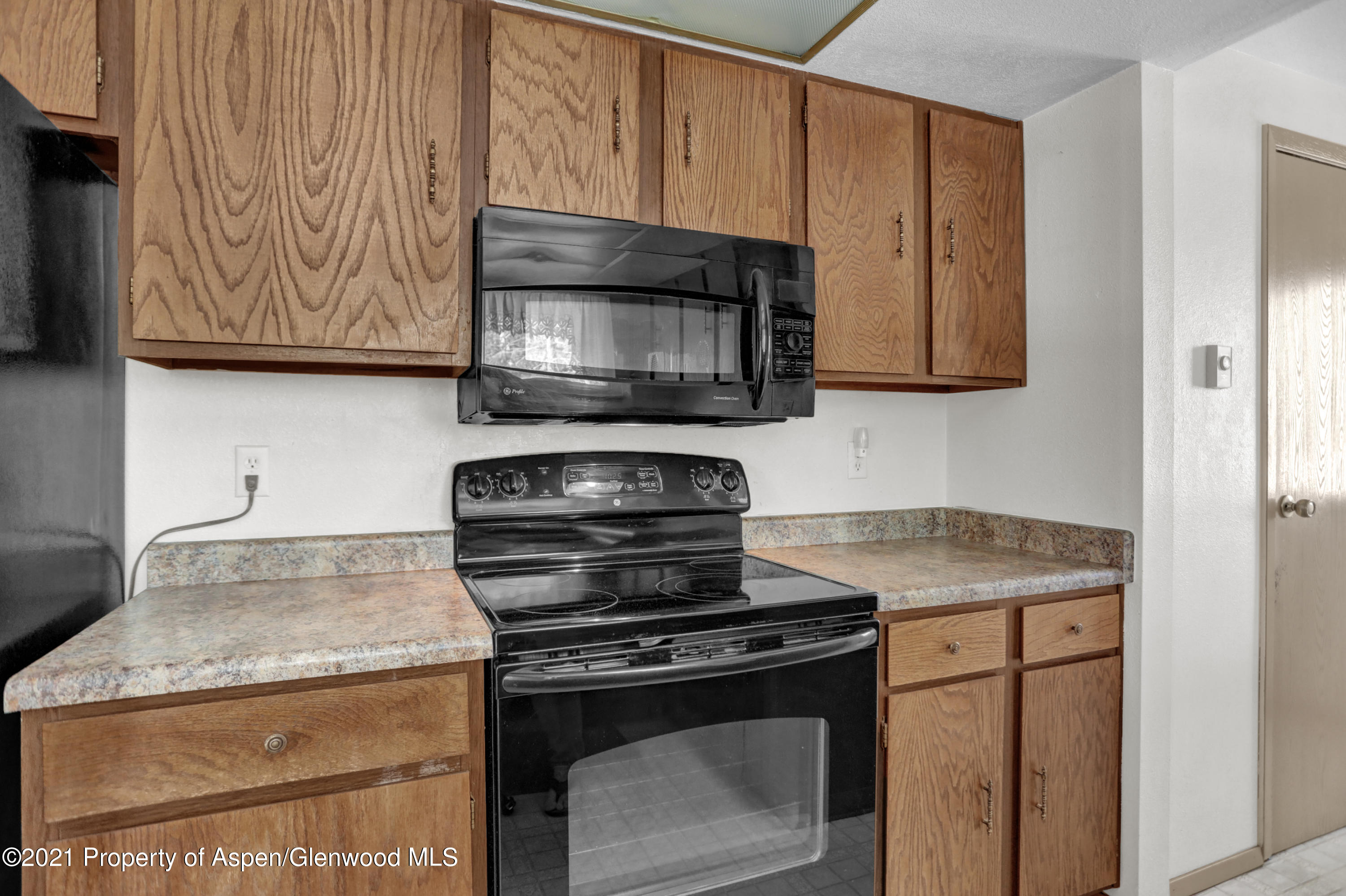 770 Bridger Circle Craig, CO 81625 - Photo 10 of 32 a kitchen with granite countertop wood cabinets stainless steel appliances and a counter space