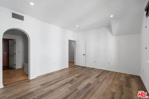 a view of walk in closet with empty racks