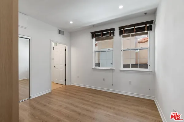 a view of a room with a table and chairs