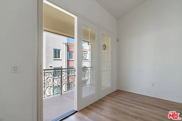 a view of a room with wooden floor and a window
