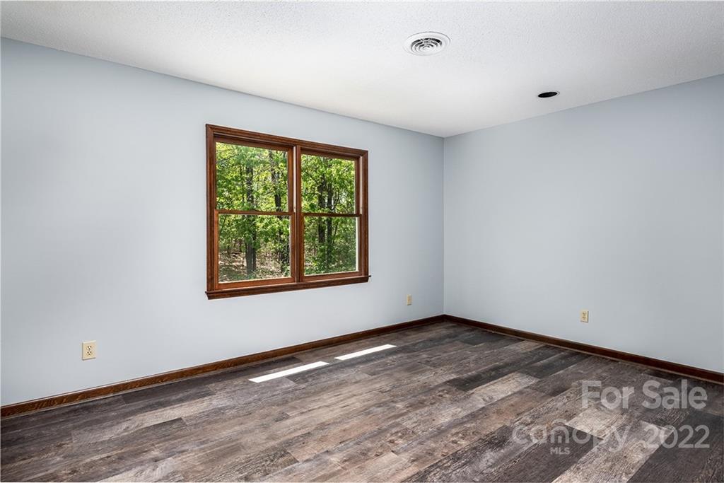 211 Westwood Drive Morganton, NC 28655 - Photo 18 of 43 a view of an empty room with wooden floor and a window
