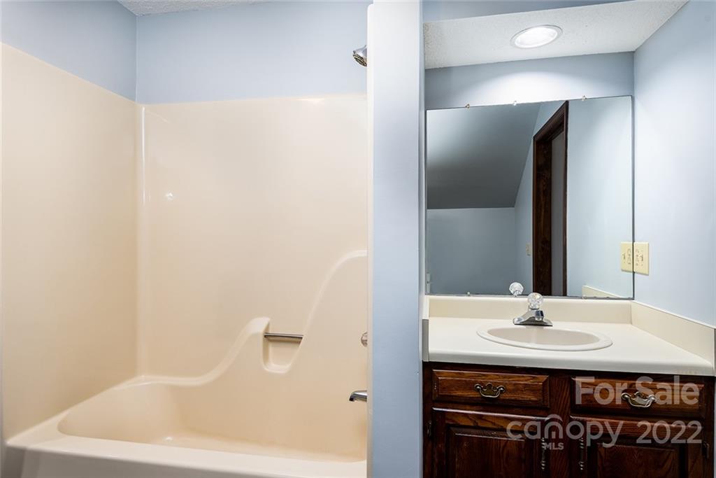 211 Westwood Drive Morganton, NC 28655 - Photo 20 of 43 a bathroom with a sink and a mirror