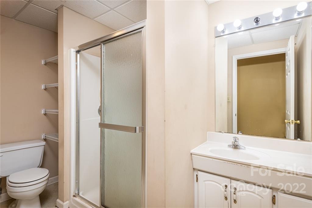 211 Westwood Drive Morganton, NC 28655 - Photo 24 of 43 a bathroom with a granite countertop sink toilet and shower