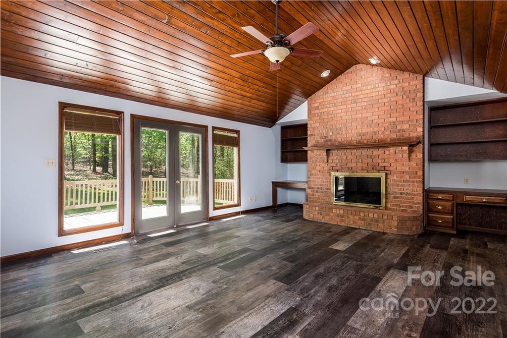 211 Westwood Drive Morganton, NC 28655 - Photo 4 of 43 a view of an empty room with a fireplace and a window