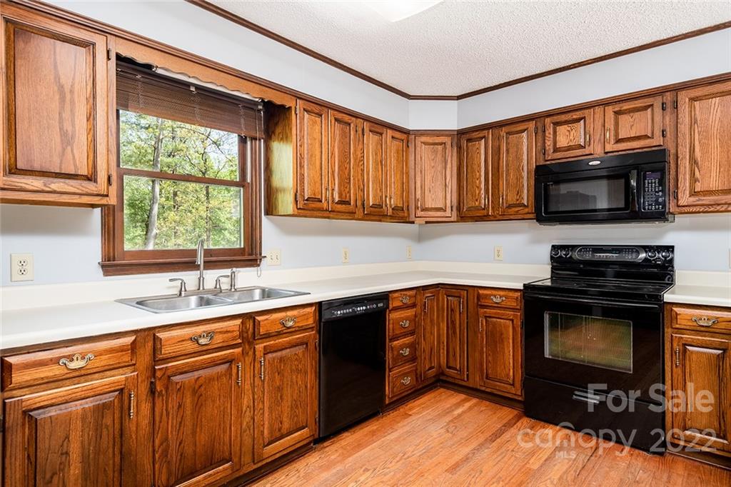211 Westwood Drive Morganton, NC 28655 - Photo 5 of 43 a kitchen with stainless steel appliances granite countertop a sink stove microwave and cabinets