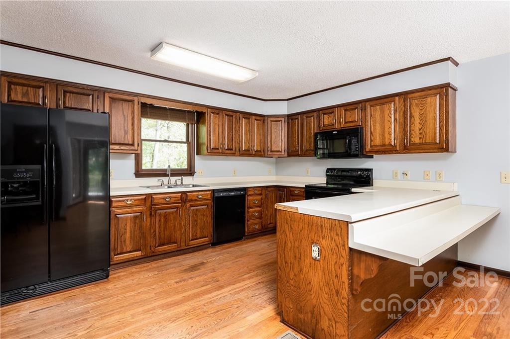 211 Westwood Drive Morganton, NC 28655 - Photo 6 of 43 a kitchen with stainless steel appliances granite countertop a refrigerator a sink dishwasher a stove and a microwave oven on dining table