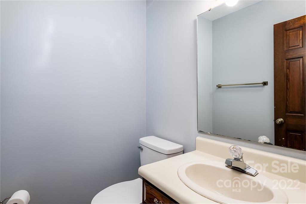 211 Westwood Drive Morganton, NC 28655 - Photo 9 of 43 a bathroom with a sink a toilet and mirror