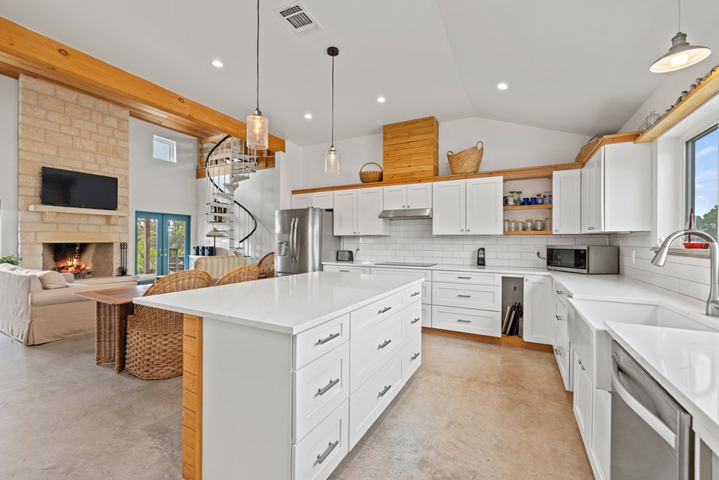 456 Colt Valley Road Fredericksburg, TX 78624 - Photo 13 of 46 a kitchen that has a lot of white cabinets and stainless steel appliances