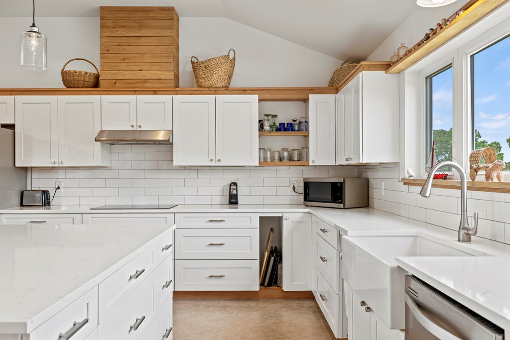456 Colt Valley Road Fredericksburg, TX 78624 - Photo 15 of 46 a kitchen with cabinets appliances a sink and a counter top space