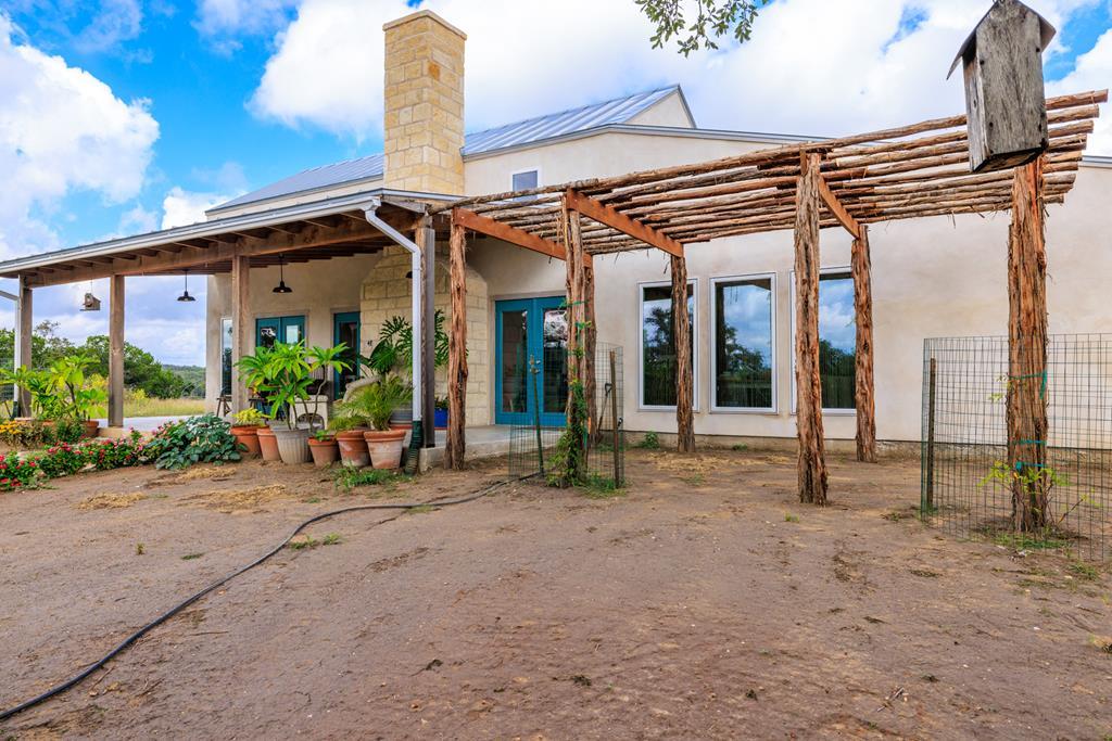 456 Colt Valley Road Fredericksburg, TX 78624 - Photo 2 of 46 a view of a house with patio