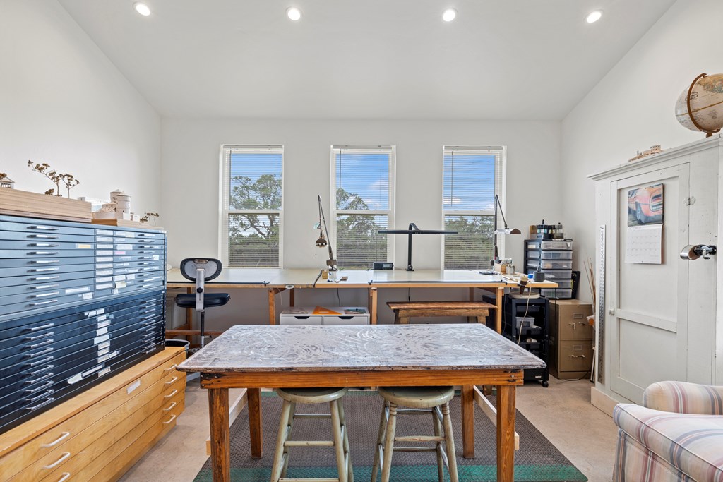 456 Colt Valley Road Fredericksburg, TX 78624 - Photo 22 of 46 a dining room with a table chairs and wooden floor