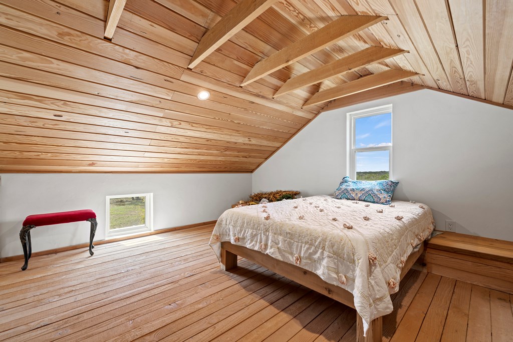 456 Colt Valley Road Fredericksburg, TX 78624 - Photo 28 of 46 a bedroom with a bed and a chair