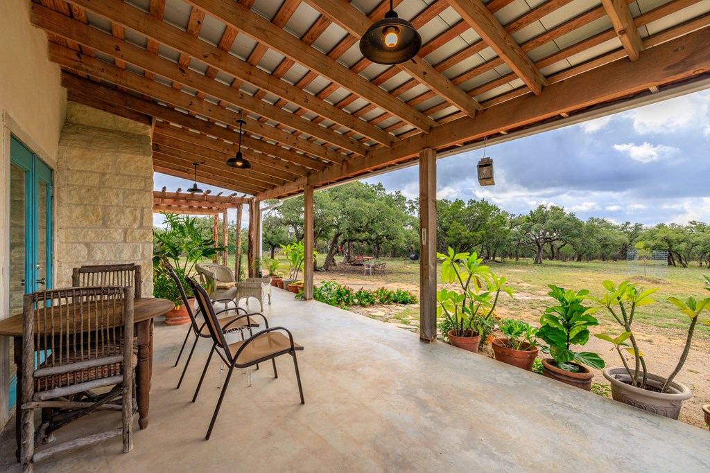 456 Colt Valley Road Fredericksburg, TX 78624 - Photo 29 of 46 a view of a chair and tables in the balcony