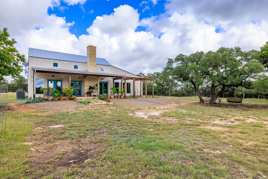 456 Colt Valley Road Fredericksburg, TX 78624 - Photo 30 of 46 a front view of a house with garden