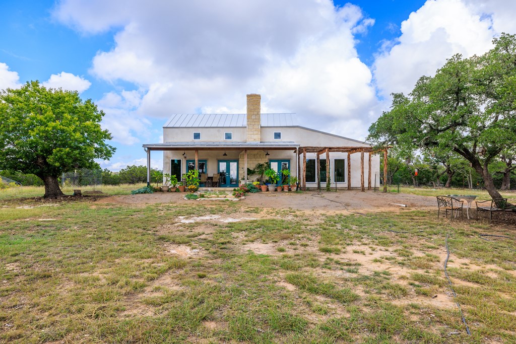 456 Colt Valley Road Fredericksburg, TX 78624 - Photo 4 of 46 a front view of a house with a yard