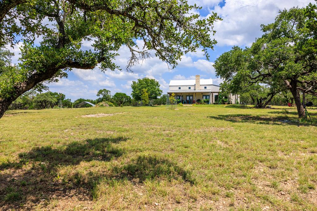 456 Colt Valley Road Fredericksburg, TX 78624 - Photo 46 of 46 a view of a large garden with plants and large trees