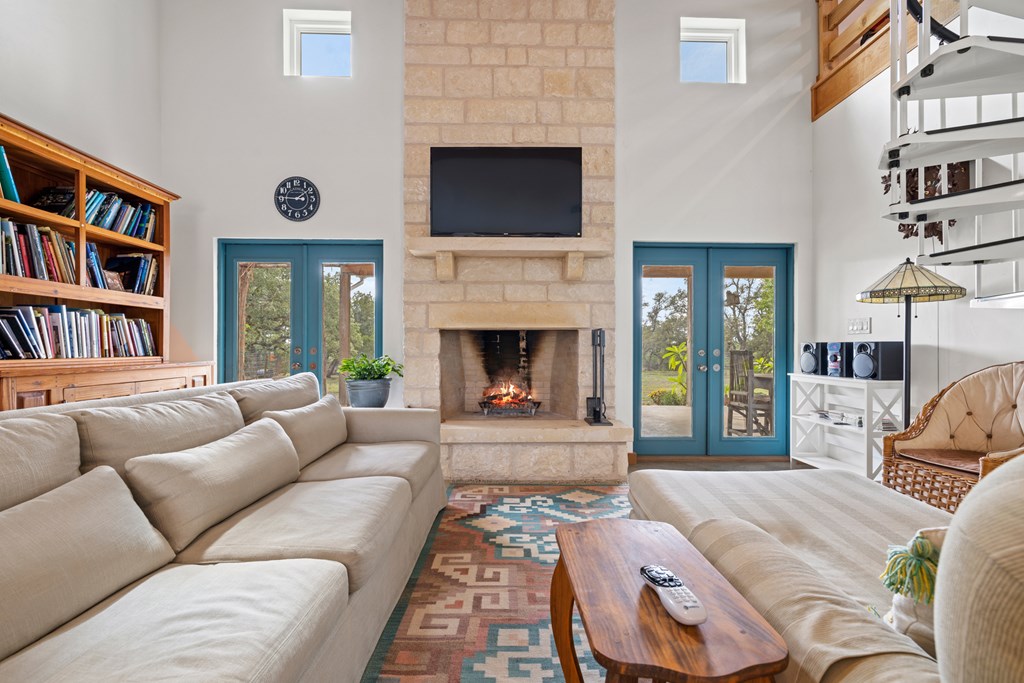 456 Colt Valley Road Fredericksburg, TX 78624 - Photo 8 of 46 a living room with furniture fireplace and flat screen tv