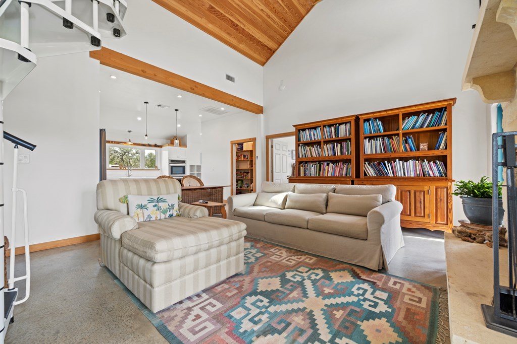 456 Colt Valley Road Fredericksburg, TX 78624 - Photo 10 of 46 a living room with furniture and a book shelf