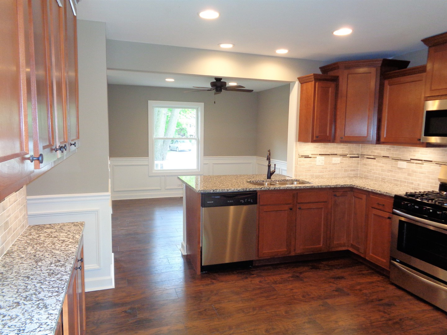 226 Seabury Road Bolingbrook, IL 60440 - Photo 3 of 24 a kitchen with stainless steel appliances granite countertop a sink and a stove top oven
