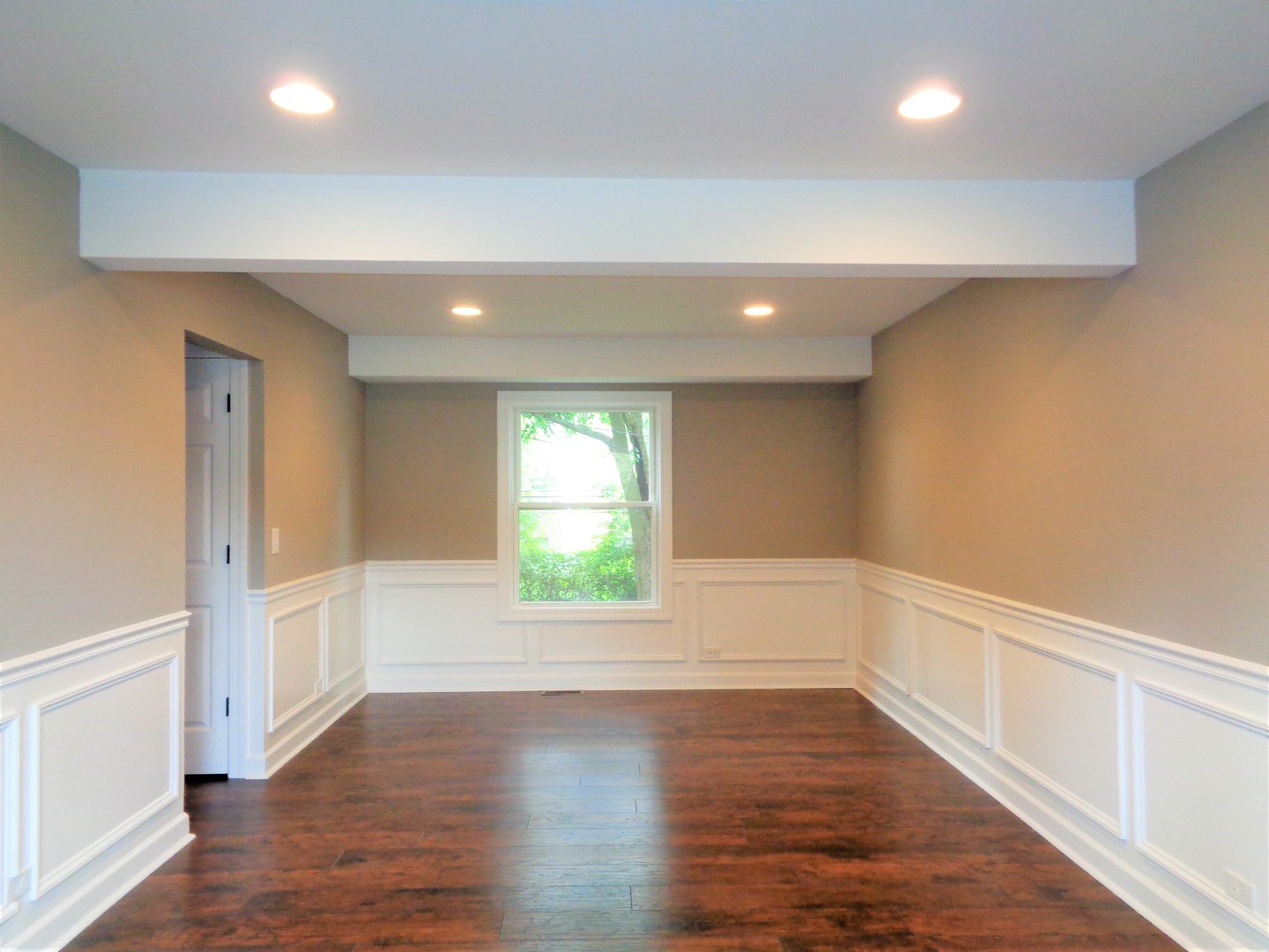 226 Seabury Road Bolingbrook, IL 60440 - Photo 7 of 24 an empty room with wooden floor and windows