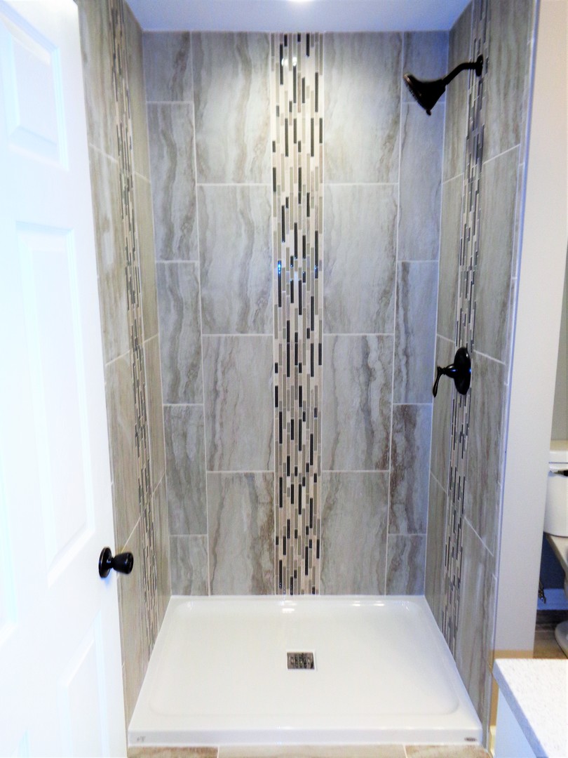 226 Seabury Road Bolingbrook, IL 60440 - Photo 9 of 24 a bathroom with a bathtub and a shower