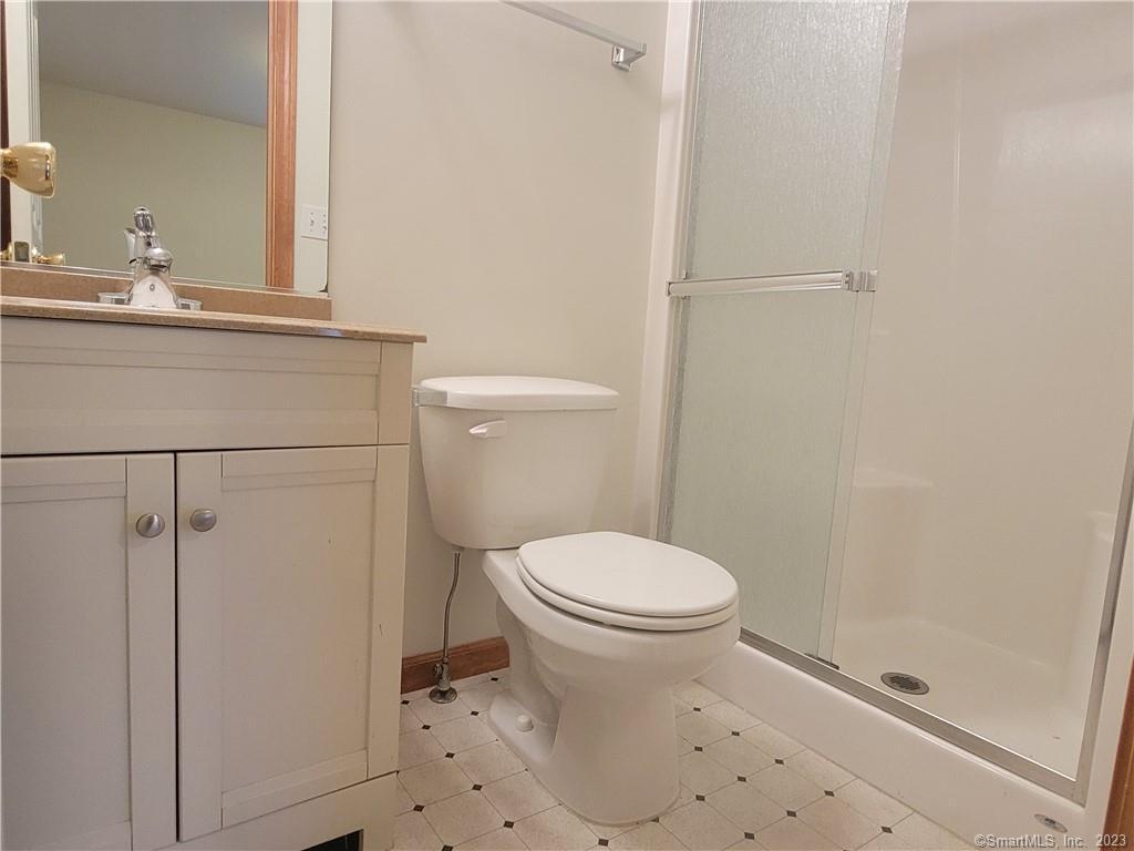 21 Bellevue Avenue, Unit B Vernon, CT 06066 - Photo 11 of 14 a bathroom with a sink a toilet and shower
