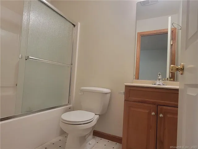 a bathroom with a toilet a sink and shower