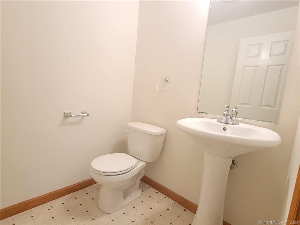 21 Bellevue Avenue, Unit B Vernon, CT 06066 - Photo 7 of 14 a bathroom with a sink a toilet and a mirror