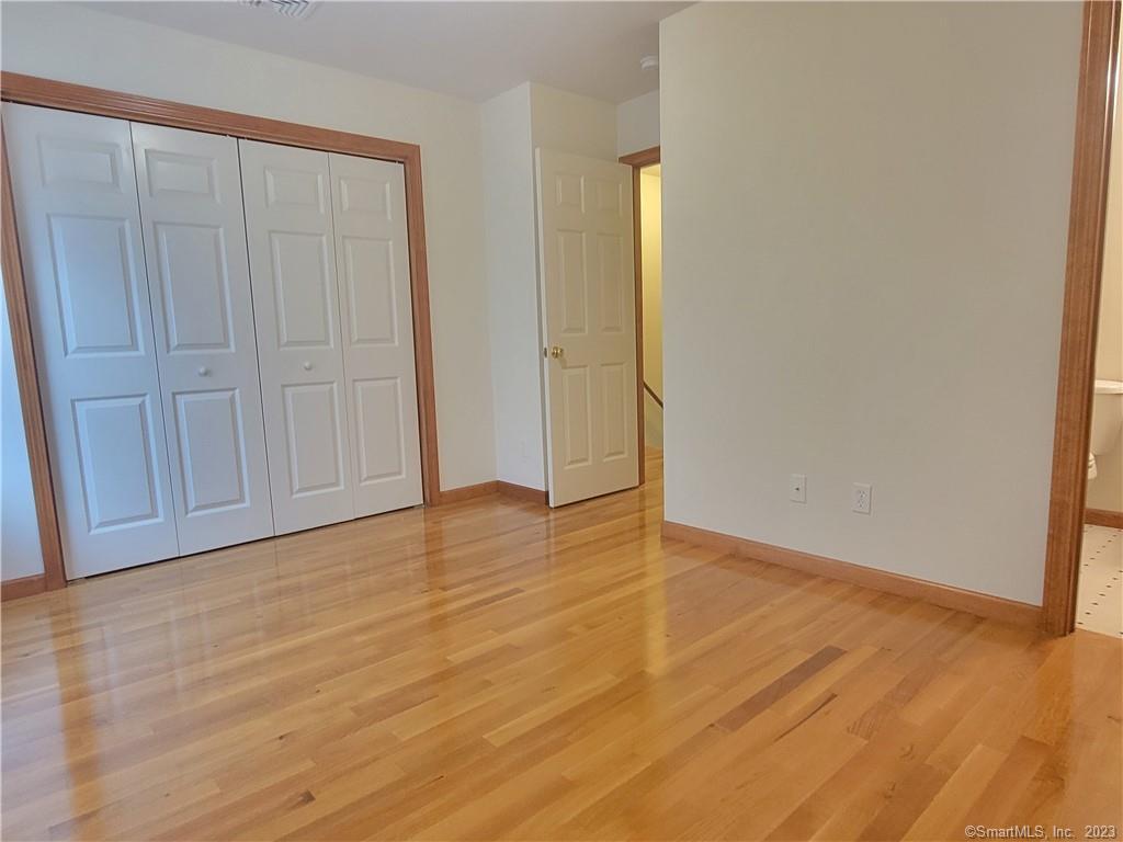21 Bellevue Avenue, Unit B Vernon, CT 06066 - Photo 10 of 14 a view of an empty room with wooden floor