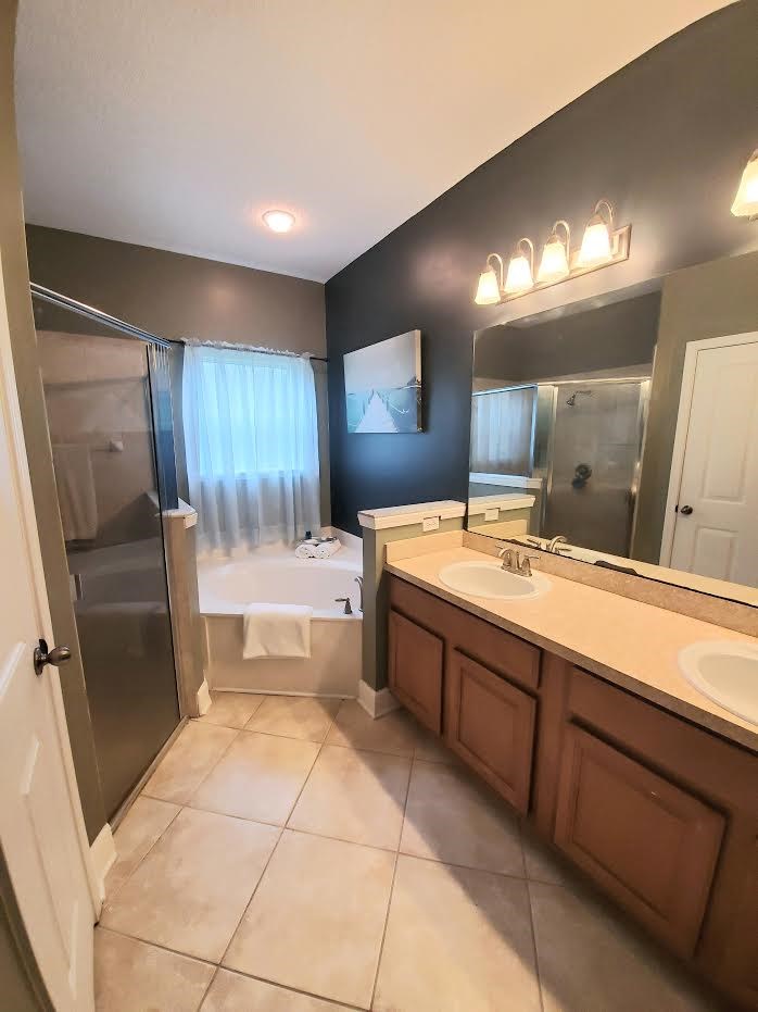 54414 Armstrong Road Callahan, FL 32011 - Photo 15 of 25 a bathroom with a large mirror vanity and a shower
