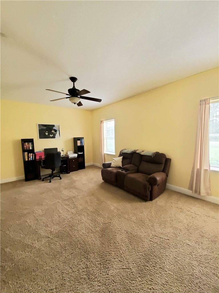 54414 Armstrong Road Callahan, FL 32011 - Photo 16 of 25 a living room with furniture and a flat screen tv