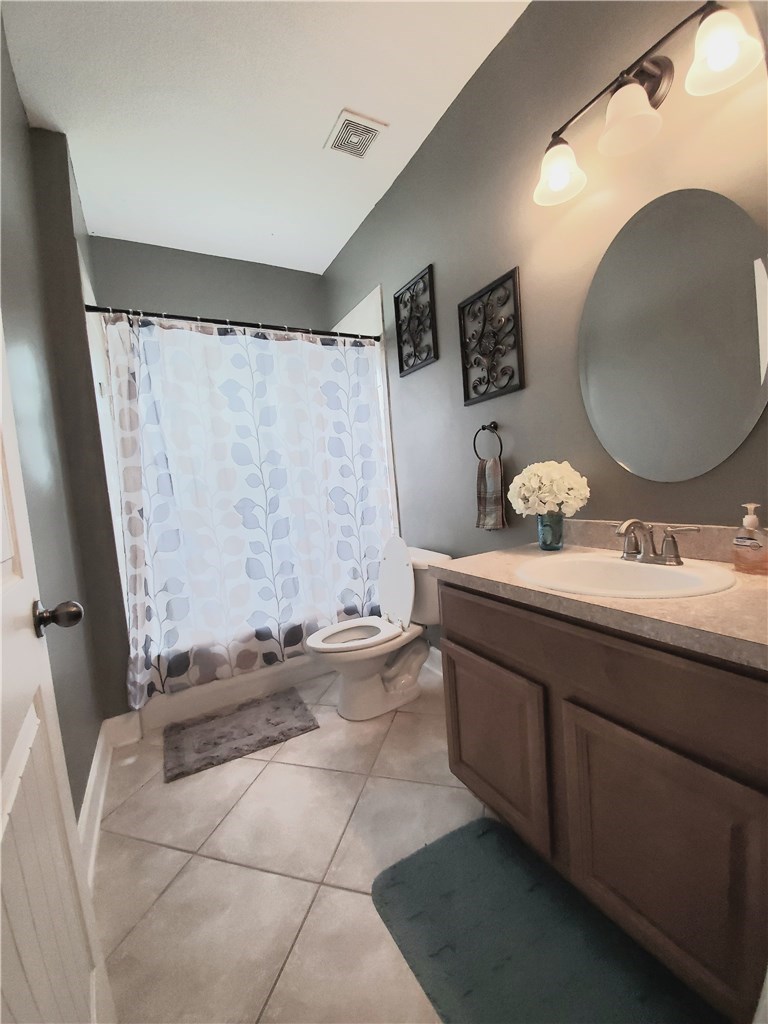 54414 Armstrong Road Callahan, FL 32011 - Photo 4 of 25 a bathroom with a sink a mirror and a toilet