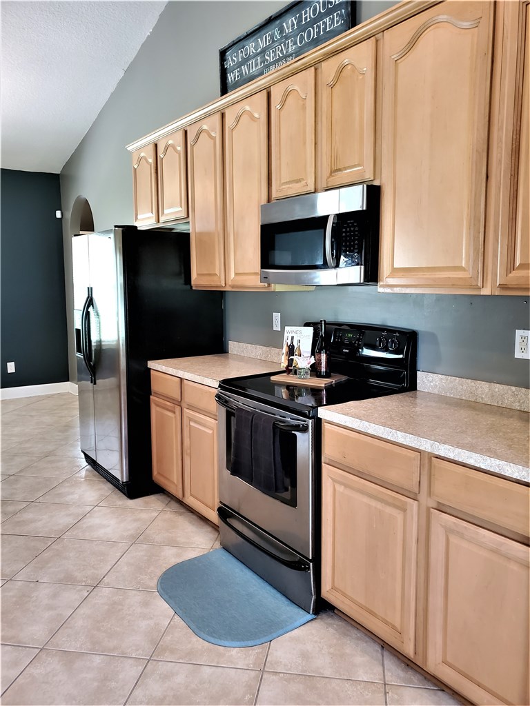 54414 Armstrong Road Callahan, FL 32011 - Photo 5 of 25 a kitchen with stainless steel appliances granite countertop a refrigerator a stove a sink and dishwasher