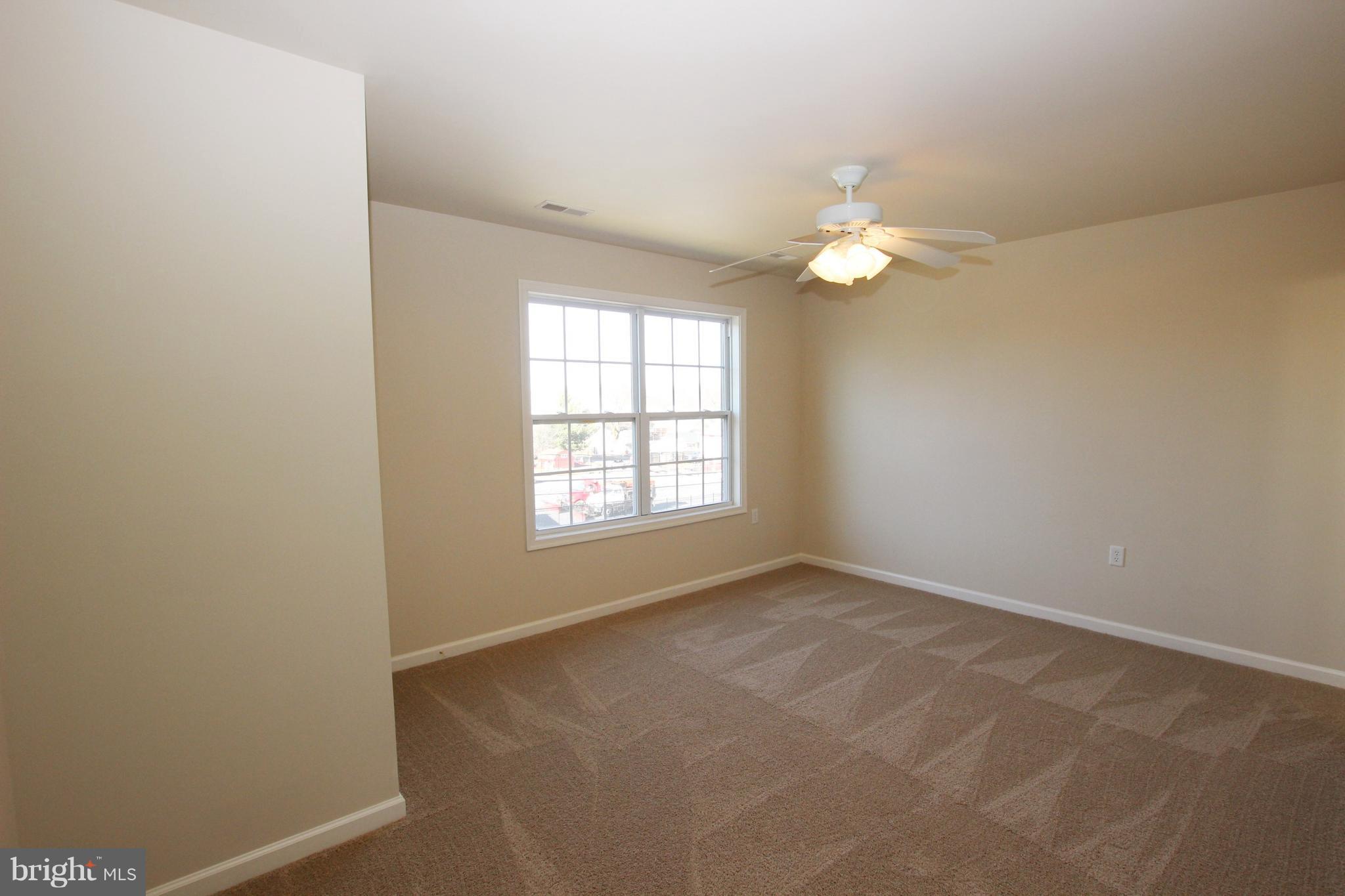 312 East 5th Avenue Ranson, WV 25438 - Photo 12 of 18 an empty room with windows and fan