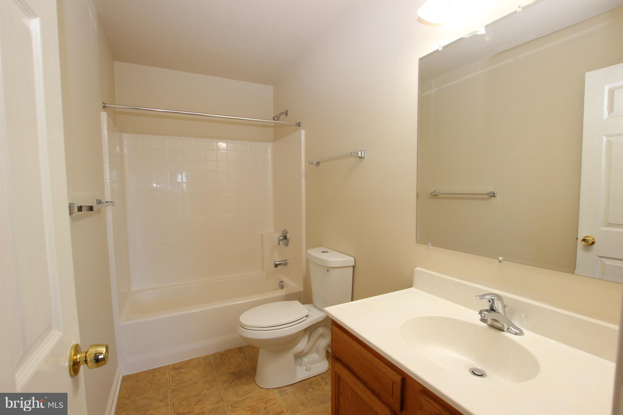 312 East 5th Avenue Ranson, WV 25438 - Photo 14 of 18 a bathroom with a sink a toilet and shower