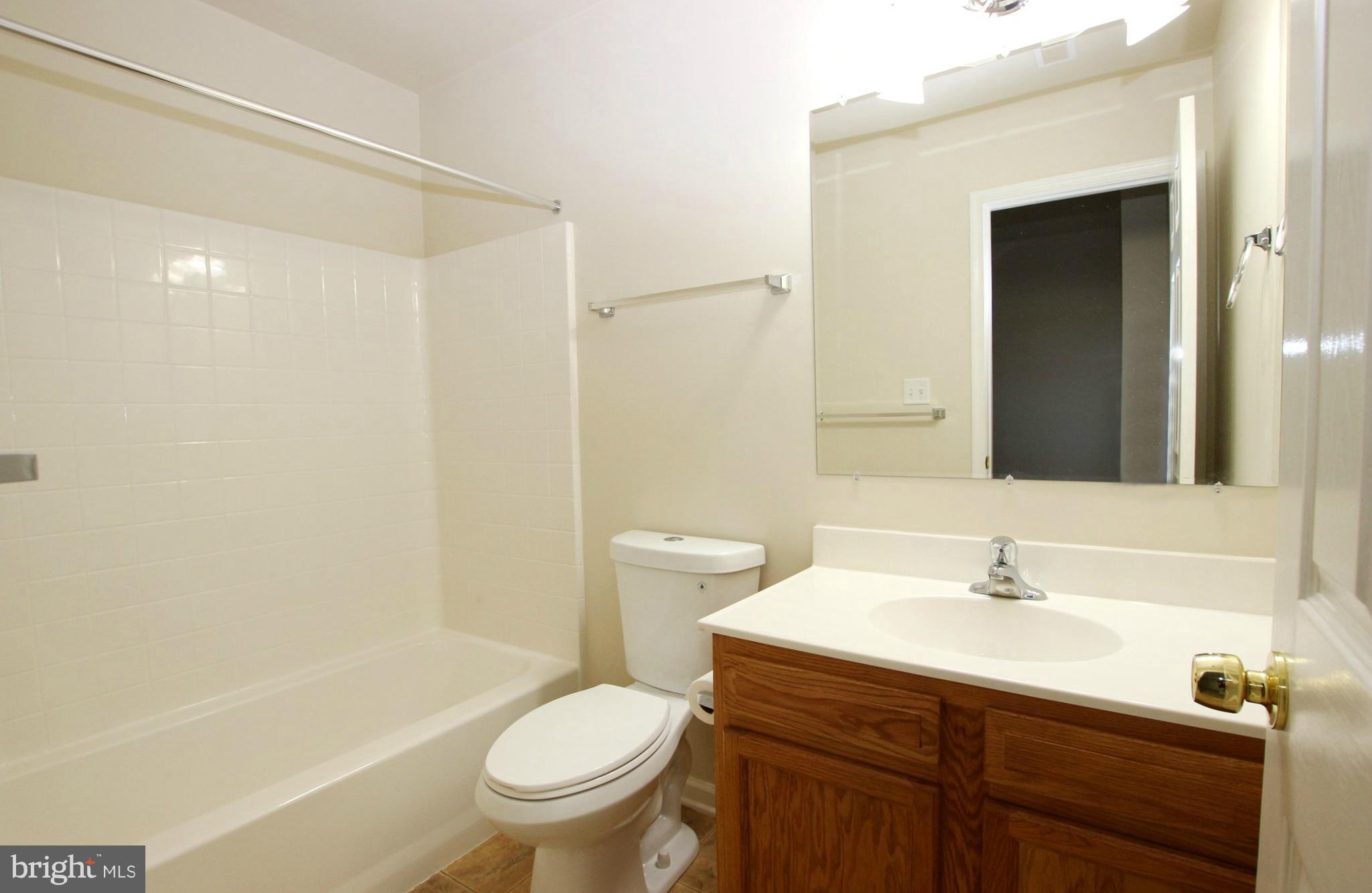 312 East 5th Avenue Ranson, WV 25438 - Photo 17 of 18 a bathroom with a sink a toilet and shower