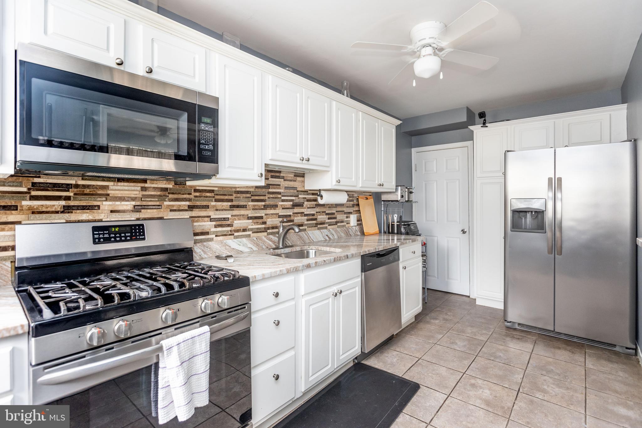1911 Ramblewood Road Baltimore, MD 21239 - Photo 11 of 29 Kitchen also features tile backsplash.