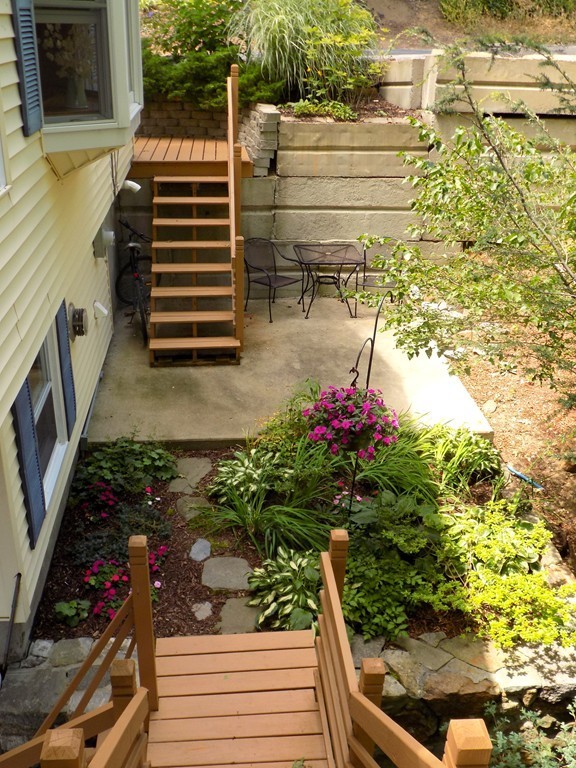 101 Sandy Beach Road Holland, MA 01521 - Photo 16 of 23 a backyard of a house with wooden fence and flowers