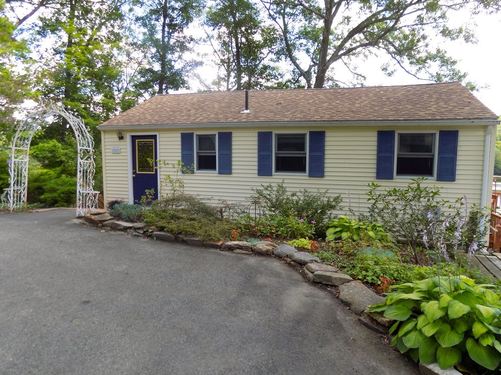 101 Sandy Beach Road Holland, MA 01521 - Photo 2 of 23 a front view of a house with a yard and garage
